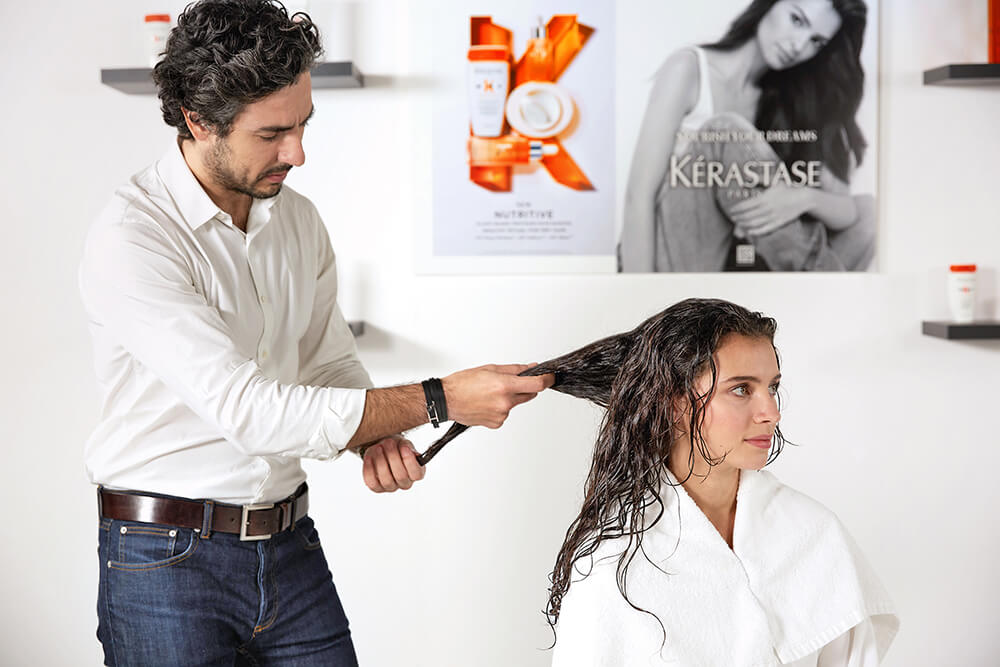 Kerastase’s Professional Hairdresser representative, Hovig – Doing client’s hair diagnostic.